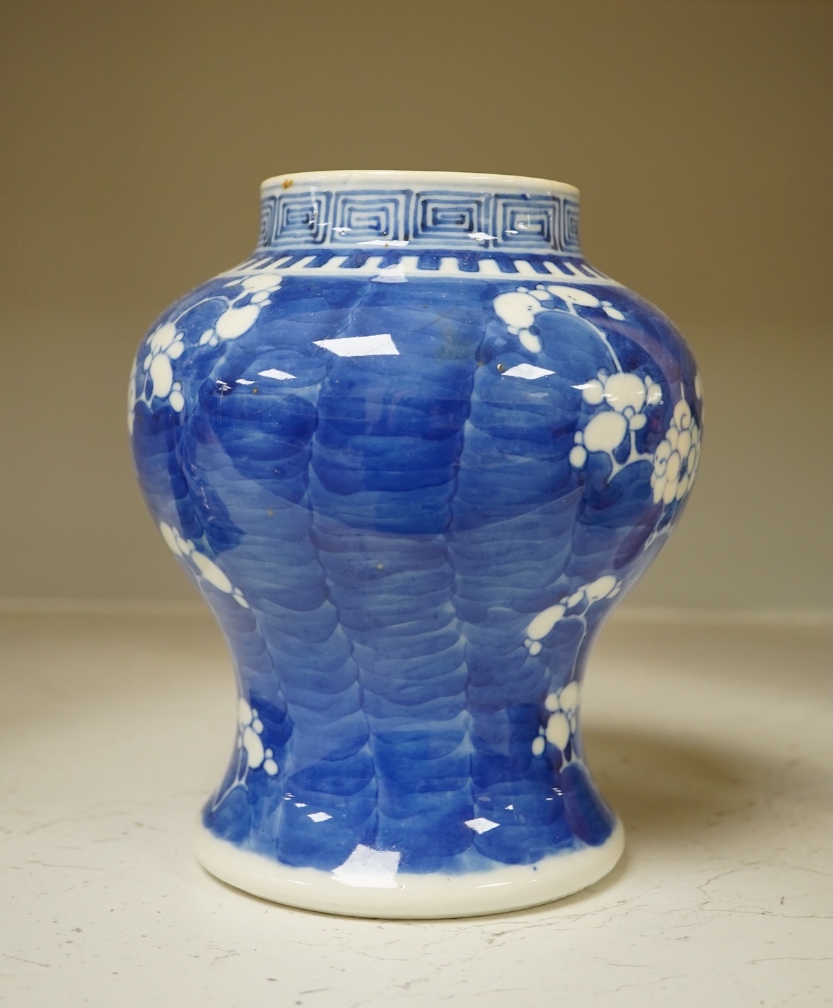 A 19th century Chinese blue and white 'prunus' vase, a Chinese green glazed jar, a Japanese vase and two dishes and two Canton famille rose plates (7). Condition - fair to good